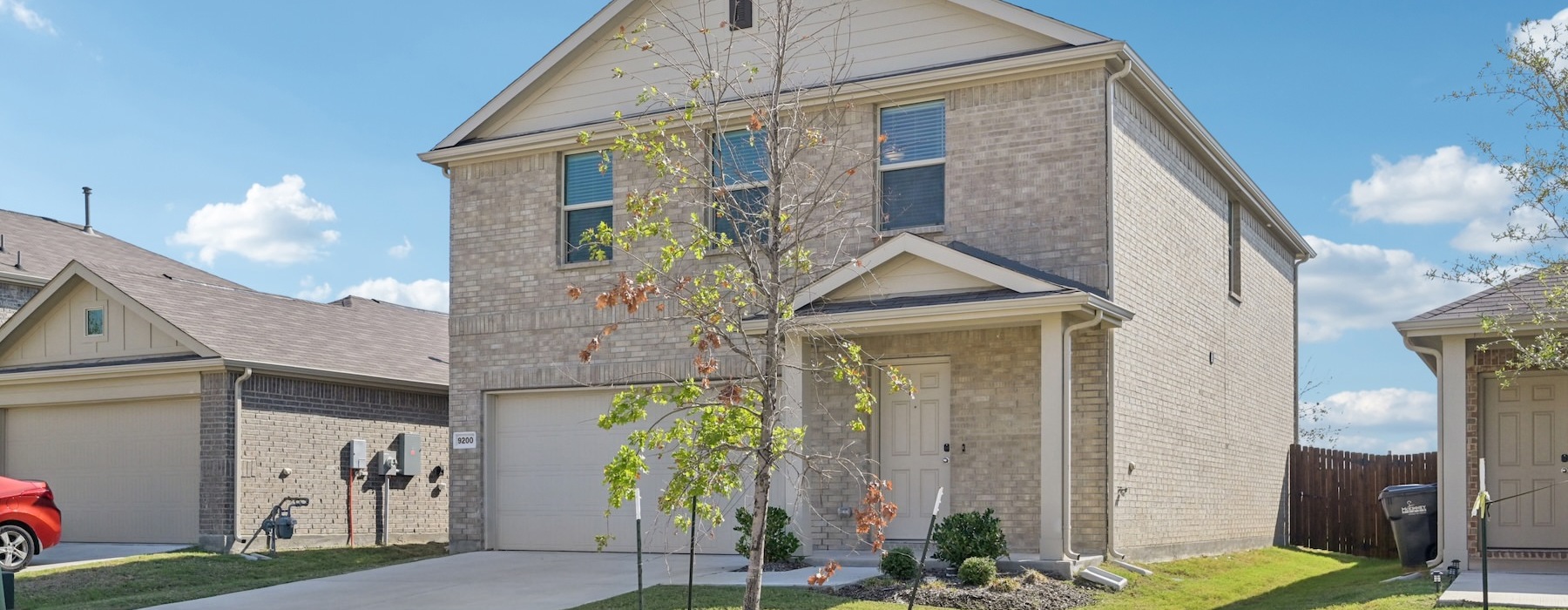 a house with a tree in the front yard