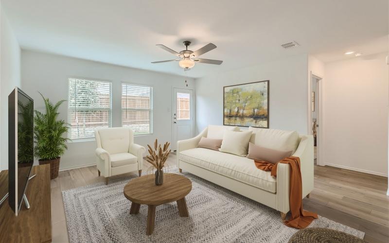 a living room with a white couch, tv and coffee table