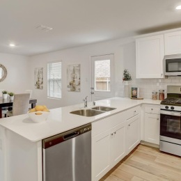 a kitchen with white cabinets