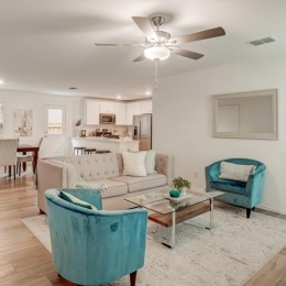 a living room with a couch, tables and chairs
